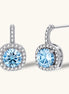 Sterling silver drop earrings featuring cushion-cut blue moissanite stones surrounded by sparkling halo settings