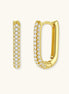 Close-up of small sterling silver huggie hoops completely covered in sparkling clear crystals with hinged closure