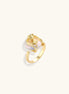 Gold-plated sculptural ring featuring a baroque pearl wrapped in a delicate rose and vine cage design