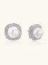 Rhodium-plated sterling silver stud earrings with round freshwater pearls surrounded by geometric crystal halos on cream background.