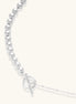 Long sterling silver beaded necklace with graduated sphere design, toggle clasp, and delicate chain extension on white background