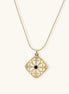 Gold filigree pendant with quatrefoil design, deep blue lapis lazuli center, clear crystal accents on ball chain