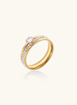 Gold-plated double-band ring with center rhinestone solitaire and channel-set stones on white background