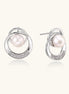 White gold-plated brass earrings with circular design, freshwater pearl center, and diamond accents