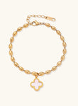 18K gold-plated oval bead chain bracelet with quatrefoil clover charm featuring mother of pearl inlay on cream background