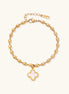 18K gold-plated oval bead chain bracelet with quatrefoil clover charm featuring mother of pearl inlay on cream background