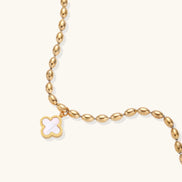 18K gold-plated oval bead chain bracelet with quatrefoil clover charm featuring mother of pearl inlay on cream background