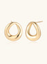 Pair of polished 18K gold-plated stainless steel teardrop earrings with hollow centers on cream background