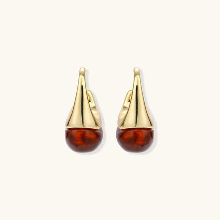 Modern drop earrings with curved gold-plated copper tops and amber resin bottoms creating an organic teardrop silhouette.