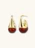 Modern drop earrings with curved gold-plated copper tops and amber resin bottoms creating an organic teardrop silhouette.